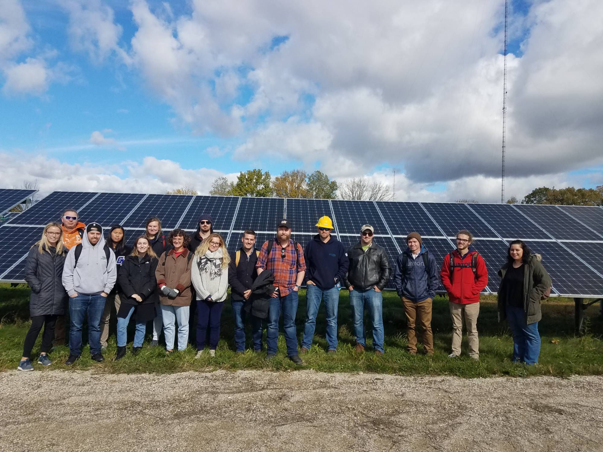 GVSU students standing in front of solar panels